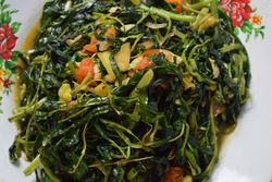 Top view of plate of cooked greens side dish