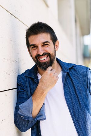 Portrait of happy Latino man in denim outside