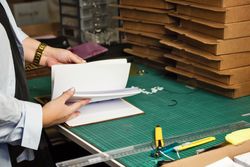 Female hands leafing through notebook with replaceable blocks