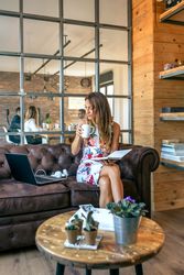 Woman drinking coffee and working in a coworking office