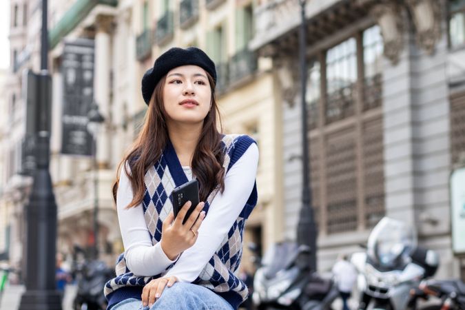 Young Asian woman using smartphone in the city