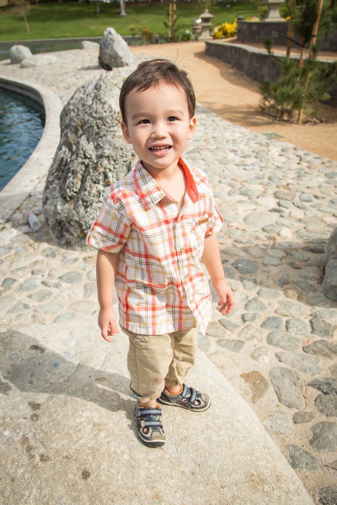 Young Biracial Boy Having Fun at the Park and Duck Pond.