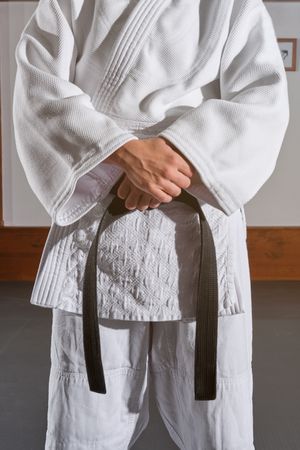 Crop man in kimono with crossed hands
