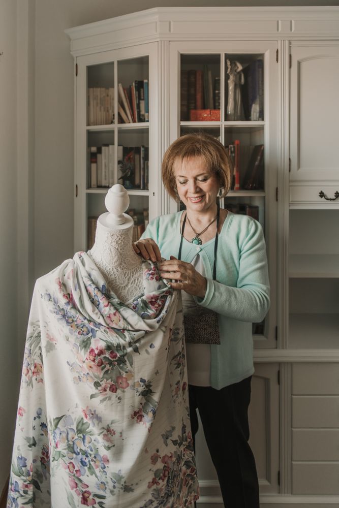 Dressmaker adjusting apparel on mannequin