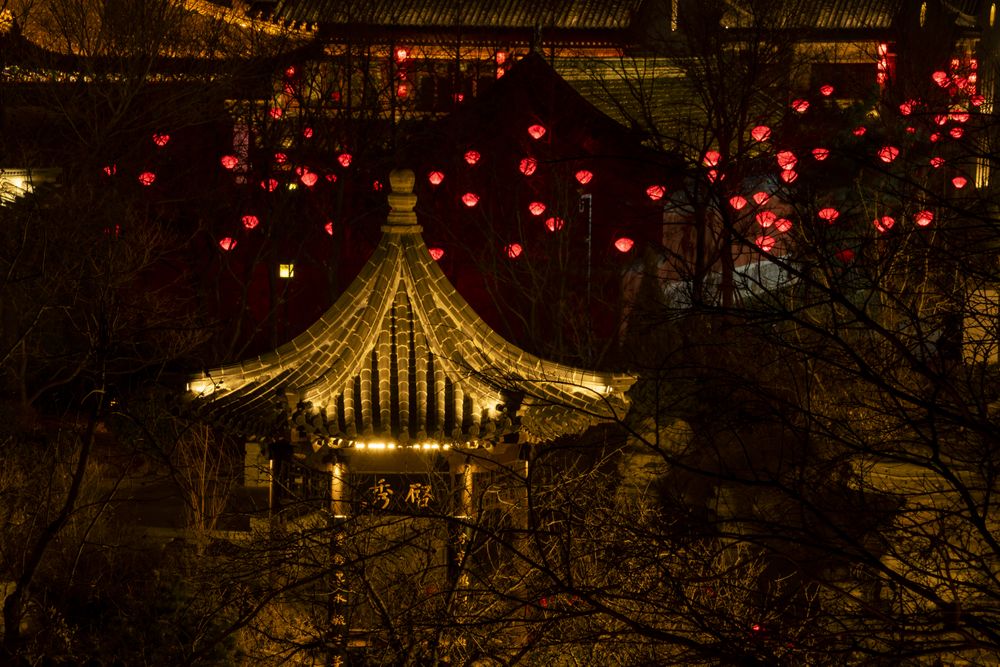 High angle view of gazebo near red lantern decoration at night
