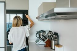 Woman turning on microwave oven