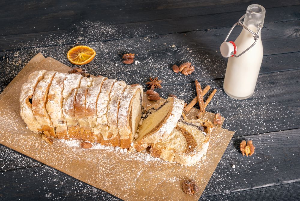 Bottle of milk and sliced pound cake on rustic wooden table