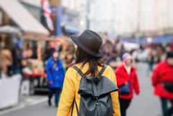 Unrecognizable tourist walking on street during festival