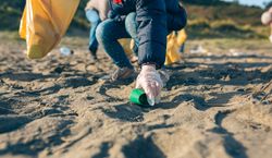 Little girl cleaning the beach