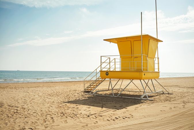 Yellow lifeguard station on an empty beach