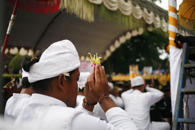 Indonesian men in Hindu prayer ceremony