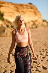 Young female walking on the sand with golden light