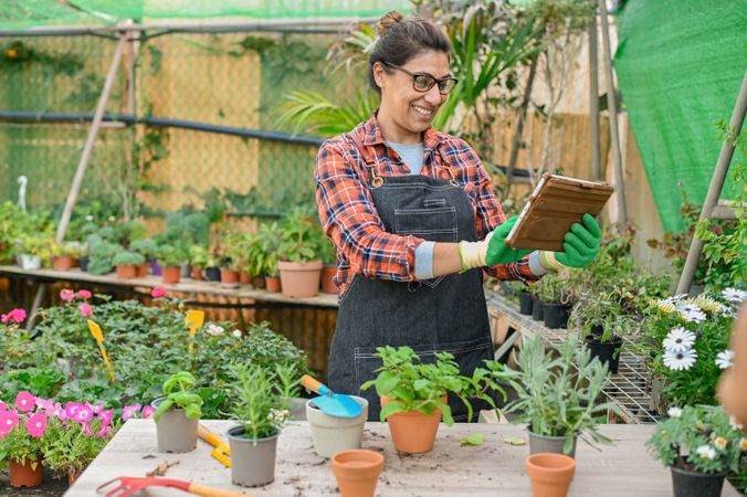 Female gardener with potted plants