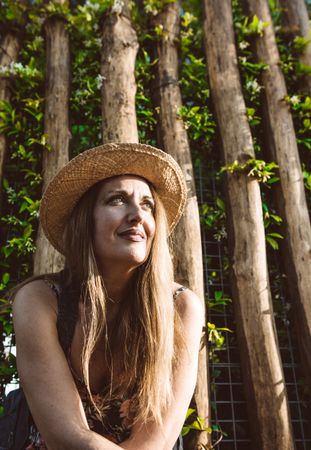 Smiling woman in straw hat looking away