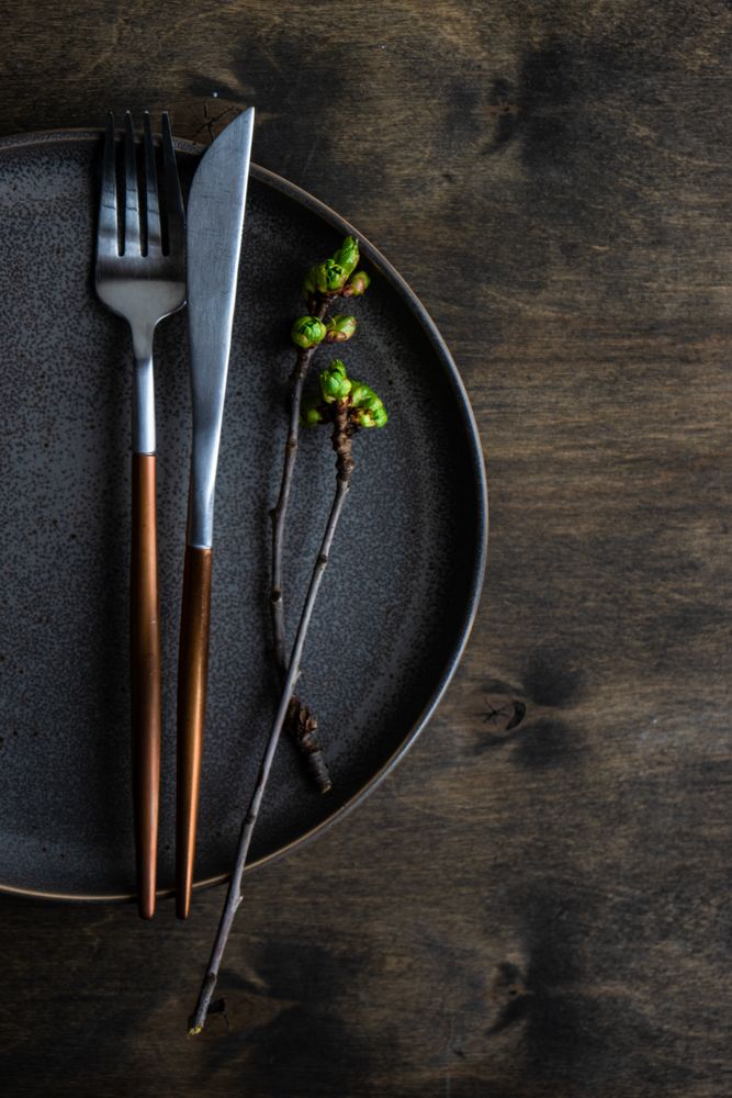 Dark plate table setting with cherry blossom branch