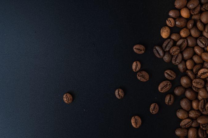 Scattered coffee beans on the side
