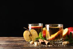 Composition with cider, sugar, cinnamon and apples on wooden table
