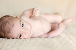 Portrait of newborn baby lying down over a blanket