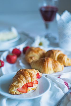 Fruit filled croissant on tablecloth