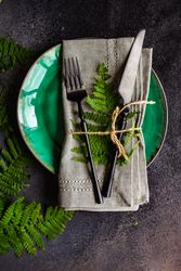 Summer rural table setting with fern on green plate