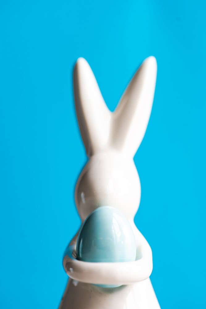Easter card concept with rabbit figuring on blue background