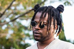 Modern man with dreadlocks and in accessories