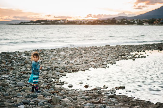 girl with stones at beach