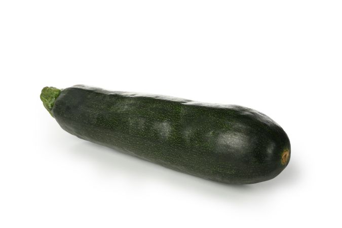 Fresh green zucchini isolated on blank background
