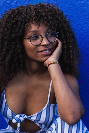 Trendy Black woman against bright wall