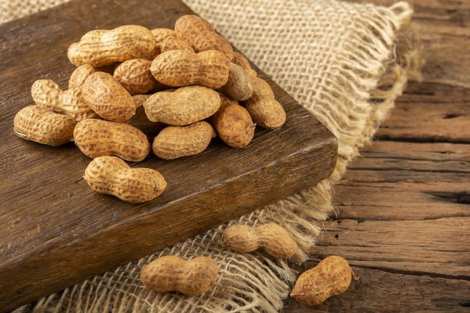 Dry peanut on the wooden background.
