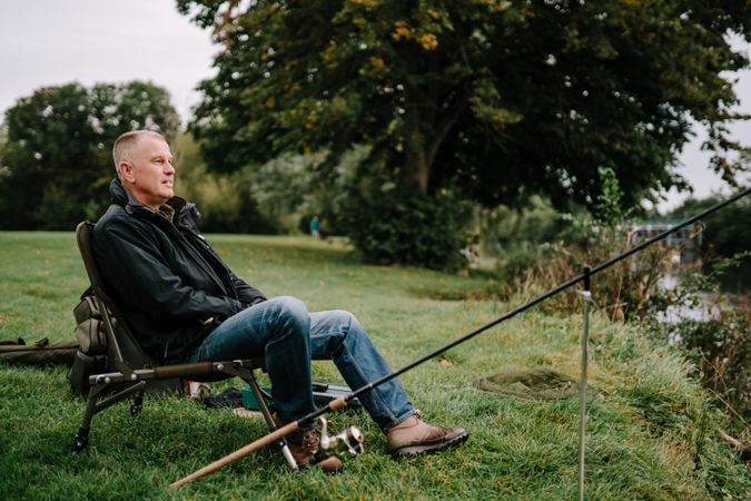 Man sitting and fishing in river