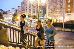 Fit women training by running up stairs in city at night bE9pk1