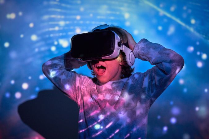 Shocked child watching movie in VR glasses