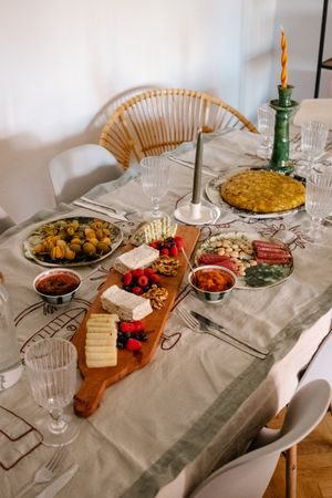 Cheese plate, meats and frittata set on casual table
