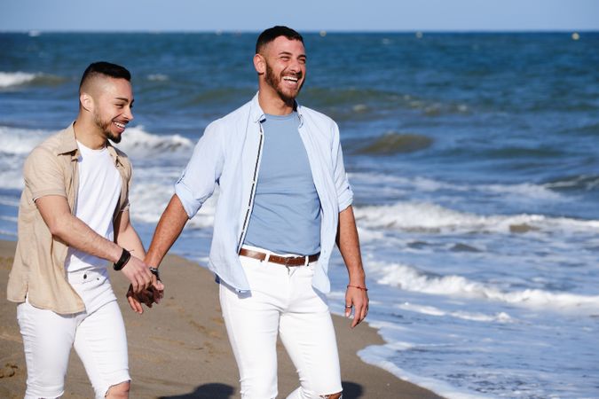 Gay couple walking on beach