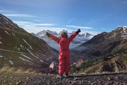 Anonymous child enjoying freedom in mountains