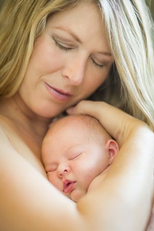 Calm Mother Holding Her Precious Newborn Baby Girl