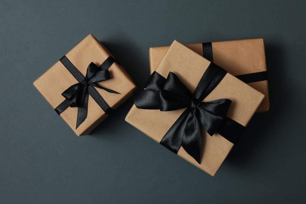Craft gift boxes with bow on gray background