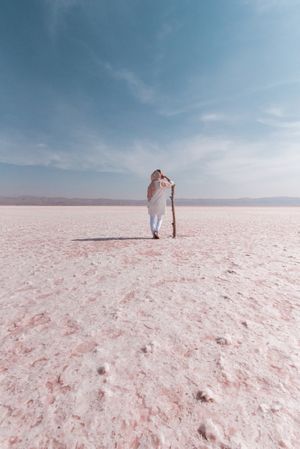 Thoughtful relaxed tourist enjoying unusual scenery of pink salt lake