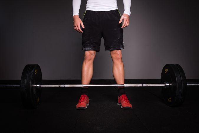 Man lifting barbell in gym