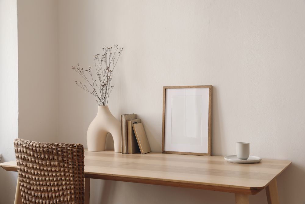Empty wooden picture frame mockup on wooden table