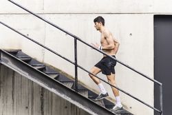 Man training and going up on steps