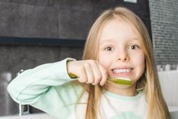 Girl holding toothbrush