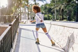 Woman on roller skates looking back at camera