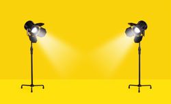 Studio lamps over yellow background