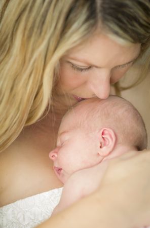 Mother Holding Her Cute Newborn Baby Girl