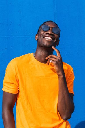 Black man in bright sporty outfit and sunglasses