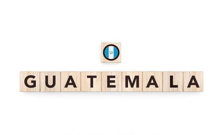 Wooden blocks bearing the name and flag of Guatemala. Guatemalan and Caribbean Culture, national identity, travel, and geography in a copy space design.
