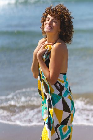 Happy woman with hand on chest on shore
