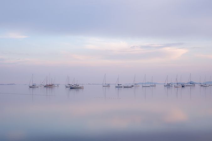 Boats on calm sea water in evening